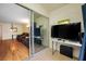 Enclosed patio featuring sliding glass doors leading into the living room with entertainment setup at 1100 E Bay Dr # 60, Largo, FL 33770