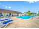 Community pool area with lounge chairs and clear blue water at 1100 E Bay Dr # 60, Largo, FL 33770
