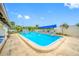 Community pool with chairs, lounge chairs, and pool shade at 1100 E Bay Dr # 60, Largo, FL 33770