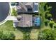 Aerial view showcases the property's backyard with pool and proximity to a pond at 11320 Lazy Hickory Ln, Tampa, FL 33635