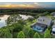 Aerial view of the backyard pool and lake creating a private oasis at 11320 Lazy Hickory Ln, Tampa, FL 33635