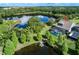 Expansive backyard with a screened-in pool, jacuzzi, and private dock on a serene lake at 11320 Lazy Hickory Ln, Tampa, FL 33635