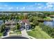 Stunning aerial view of a home with lush landscaping and a private lake in a desirable community at 11320 Lazy Hickory Ln, Tampa, FL 33635