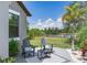 Relaxing back patio with lake view, seating area and palm tree for enjoying the outdoors at 11320 Lazy Hickory Ln, Tampa, FL 33635