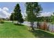 Backyard with beautiful view of the lake and lush trees at 11320 Lazy Hickory Ln, Tampa, FL 33635