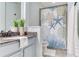 Bright bathroom featuring a toilet, shower with a starfish-themed curtain, and a granite countertop vanity at 11320 Lazy Hickory Ln, Tampa, FL 33635