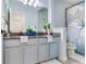 Bathroom vanity with granite countertop, double sinks, and coastal decor at 11320 Lazy Hickory Ln, Tampa, FL 33635