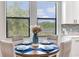 Dining area with natural light offers seating for four and backyard view through large windows at 11320 Lazy Hickory Ln, Tampa, FL 33635