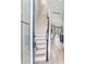 Inviting entryway showcasing the staircase and hardwood floors leading to the kitchen and living spaces at 11320 Lazy Hickory Ln, Tampa, FL 33635