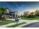 Well-maintained home with a landscaped yard, lush green grass, and palm trees at 11320 Lazy Hickory Ln, Tampa, FL 33635
