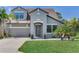 Charming two-story home with a well-manicured lawn, inviting entrance, and attached garage at 11320 Lazy Hickory Ln, Tampa, FL 33635
