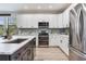 Spacious kitchen with white cabinets, stainless steel appliances, and a stylish backsplash at 11320 Lazy Hickory Ln, Tampa, FL 33635