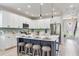Modern kitchen featuring a center island, bar stools, stainless steel appliances, and stylish backsplash at 11320 Lazy Hickory Ln, Tampa, FL 33635