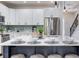 Bright kitchen features a spacious marble island, stainless appliances, and white cabinetry at 11320 Lazy Hickory Ln, Tampa, FL 33635