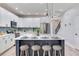 Bright kitchen features a spacious island with seating, stainless appliances, and white cabinetry at 11320 Lazy Hickory Ln, Tampa, FL 33635