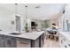 Open-concept kitchen with island and seating, overlooking the dining area and living room at 11320 Lazy Hickory Ln, Tampa, FL 33635