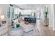 Open-concept living space with white cabinets, kitchen island, and lots of natural light at 11320 Lazy Hickory Ln, Tampa, FL 33635