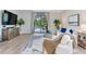 Comfortable living room features a white sofa set, stylish decor, and sliding door access to the patio at 11320 Lazy Hickory Ln, Tampa, FL 33635