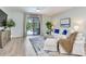 Cozy living room offers a pool view, white sofa set, and an entertainment area at 11320 Lazy Hickory Ln, Tampa, FL 33635