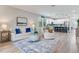 Bright and airy living room featuring an open layout to the kitchen with island seating at 11320 Lazy Hickory Ln, Tampa, FL 33635