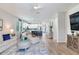 Spacious open-concept living room and kitchen area with light-colored decor and wood-look floors at 11320 Lazy Hickory Ln, Tampa, FL 33635