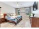 Cozy main bedroom with wood furniture, soft lighting, and two windows overlooking the outdoors at 11320 Lazy Hickory Ln, Tampa, FL 33635