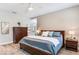 Spacious main bedroom with wood floors, stylish decor, and an ensuite bathroom at 11320 Lazy Hickory Ln, Tampa, FL 33635