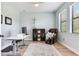 Bright home office featuring a modern desk, comfortable chair, and natural light from the windows at 11320 Lazy Hickory Ln, Tampa, FL 33635