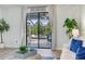 View of outdoor patio area with pool, visible from inside the living room with modern decor at 11320 Lazy Hickory Ln, Tampa, FL 33635