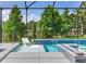 Inviting screened pool with a tanning ledge and relaxing lake views at 11320 Lazy Hickory Ln, Tampa, FL 33635