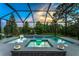Stunning backyard pool and spa with a screened enclosure and tropical landscaping at 11320 Lazy Hickory Ln, Tampa, FL 33635