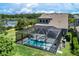 A screened pool and spa offer a relaxing outdoor retreat with ample lounging space and lush surroundings at 11320 Lazy Hickory Ln, Tampa, FL 33635