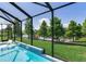 Screened pool with waterfall feature offers beautiful views of the backyard and lake at 11320 Lazy Hickory Ln, Tampa, FL 33635
