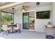 Relaxing screened porch with outdoor dining area and view of the serene lake at 11320 Lazy Hickory Ln, Tampa, FL 33635