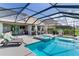 Spacious screened-in patio featuring a pool, spa, outdoor kitchen, and comfortable seating areas at 11320 Lazy Hickory Ln, Tampa, FL 33635
