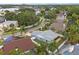Aerial view of the house with a screened-in patio, large yard, and mature landscaping at 11619 Fox Creek Dr, Tampa, FL 33635