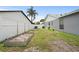 Spacious backyard with raised garden beds and a white fence, perfect for gardening and outdoor activities at 11619 Fox Creek Dr, Tampa, FL 33635