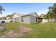 Exterior view of the house and backyard, featuring a screened patio and swing set at 11619 Fox Creek Dr, Tampa, FL 33635