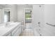 This bathroom features a shower-tub combo, tile floors, and white vanity with a sink at 11619 Fox Creek Dr, Tampa, FL 33635