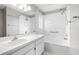 Bright bathroom with a large mirror, white vanity, and shower-tub combination at 11619 Fox Creek Dr, Tampa, FL 33635