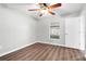 An airy bedroom with hard wood floors, ceiling fan and a bright window, great natural light at 11619 Fox Creek Dr, Tampa, FL 33635