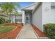 Inviting entrance with a well-manicured lawn, beautiful landscaping, and a charming entryway at 11619 Fox Creek Dr, Tampa, FL 33635