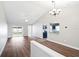 Spacious living room showcasing elegant flooring, contemporary lighting, and seamless flow to the kitchen and backyard at 11619 Fox Creek Dr, Tampa, FL 33635