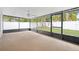 Relaxing screened-in patio with a ceiling fan overlooking the backyard with a swing set at 11619 Fox Creek Dr, Tampa, FL 33635
