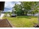 Expansive backyard with lush green lawn, mature trees, and inviting patio seating area, perfect for outdoor entertaining at 119 N Hillcrest Ave, Clearwater, FL 33755