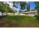 Expansive backyard with lush green grass and a privacy fence creating a serene outdoor oasis at 119 N Hillcrest Ave, Clearwater, FL 33755