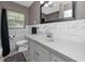 Bright bathroom features vanity with marble countertops, white tiling, and a shower and tub at 119 N Hillcrest Ave, Clearwater, FL 33755