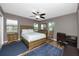 Comfortable bedroom featuring warm lighting and laminate flooring, complete with a home office at 119 N Hillcrest Ave, Clearwater, FL 33755