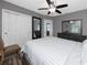 Comfortable bedroom featuring warm lighting, laminate flooring and dresser storage at 119 N Hillcrest Ave, Clearwater, FL 33755