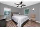 Comfortable bedroom featuring warm lighting and laminate flooring at 119 N Hillcrest Ave, Clearwater, FL 33755